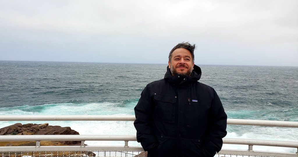 Mehrdad Hajibabaei on a ship deck at Cape Spear, Newfoundland